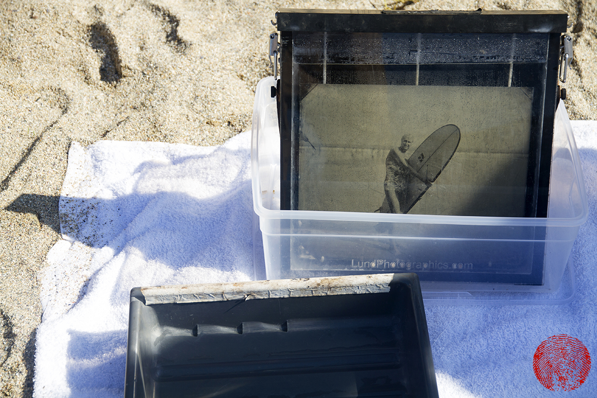 developing a tin type photograph of surfer gwynn haslock on the beach for surfland