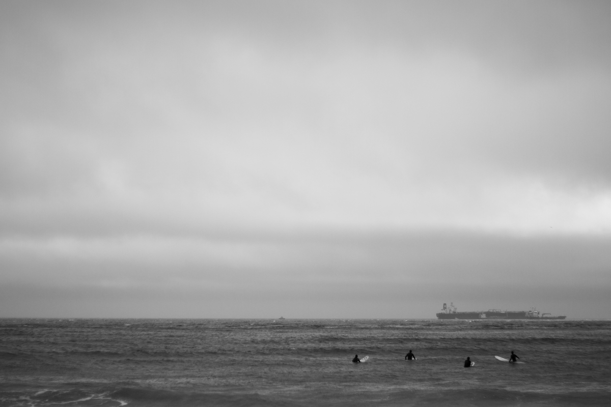 surfers waiting for waves in bad weather in the middle of winter