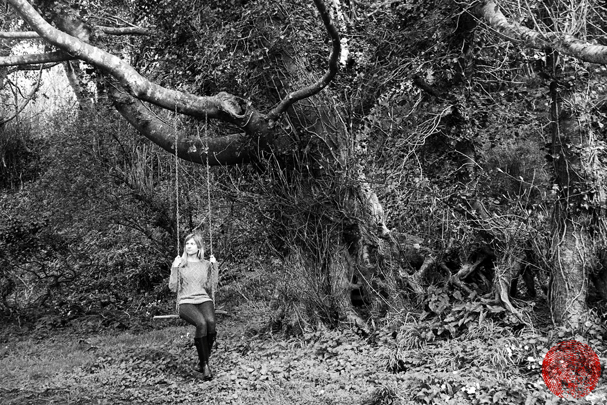 lady on a swing hanging from a tree branch, shot with a zorki 4k rangefinder vintage camera